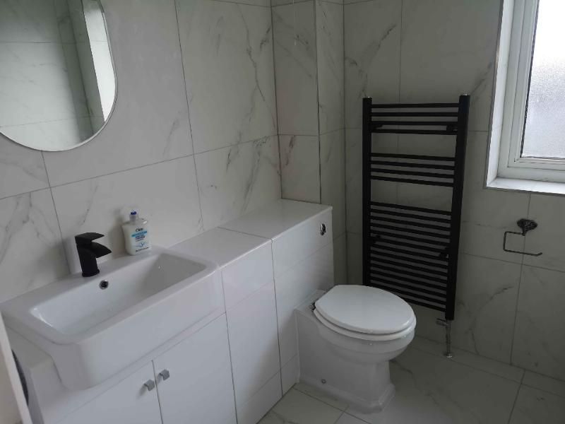 Black fittings, marble-effect tiles